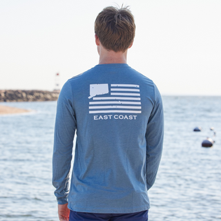 A person in Connecticut wearing a long sleeve 203 T-shirt with a graphic that says 'EAST COAST' on the back